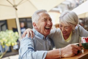 Happy older couple laughing outside